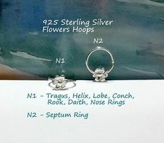 two silver rings sitting on top of a piece of paper with the names of each ring