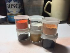 there are four spices in the containers on the table