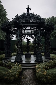 a gazebo with statues in the middle of it