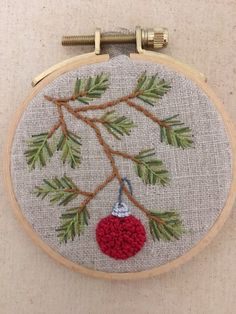 an embroidered christmas ornament hanging on a wall