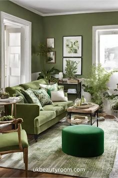 a living room with green furniture and plants in the corner, along with pictures on the wall