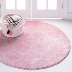 a pink area rug with a basket on the floor