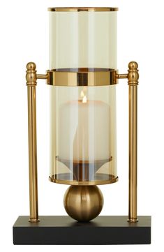 Illuminate your space with a touch of style. Perfect for any room, this table lamp will make a refreshing and stylish addition to your space. 8" x 4" x 13" Iron/glass/polyethylene Imported Abstract Candle, Table Candle Holders, Apartment Vibes, Modern Candle Holders, Cosmoliving By Cosmopolitan, Gold Candle Holders, Modern Candles, Candle Table, Candle Plate