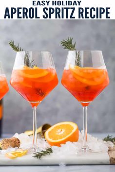 three wine glasses filled with aperol spritz and garnished with rosemary