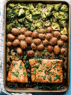 salmon and broccoli in a baking dish with potatoes, parsley on the side