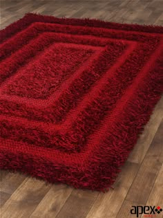 a red rug on the floor with wooden floors