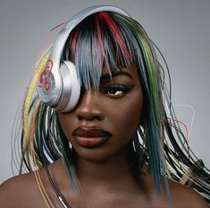 a woman with colorful hair and headphones on