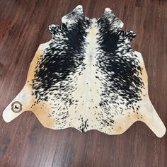 a cowhide rug with black and white spots