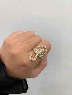 Scorpion ring in 14k gold, with cubic zirconias that add brightness to the piece, size 8 but we can make it to the custom you need, very detailed piece, made in italy, it is a piece that can be used for ladies and gentlemen, yes you have a question send a message, item sold by piece , weight undetermined. Gold Snake Ring With Diamond Accents As Gift, Gold Snake Ring With Diamond Accents For Gift, Gold Diamond Snake Ring For Anniversary, Gold Engraved Diamond Open Ring, Gold Diamond Engraved Open Ring, Gold Snake Ring With Brilliant Cut Diamonds, Yellow Gold Snake Ring With Diamond Accents For Gift, Gold Diamond Snake Ring With Brilliant Cut, Luxury Gold Engraved Ring With Cubic Zirconia