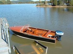 a small boat is docked at the dock