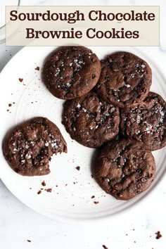 chocolate brownie cookies on a white plate with the words, sourdough chocolate brownie cookies