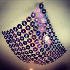 a chandelier made out of cds hanging from the ceiling