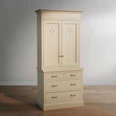 a white armoire sitting on top of a hard wood floor next to a wall