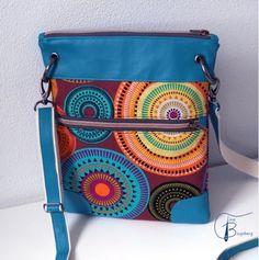 a colorful purse sitting on top of a white table