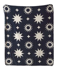 a black and white blanket with stars in the middle, on top of a white background