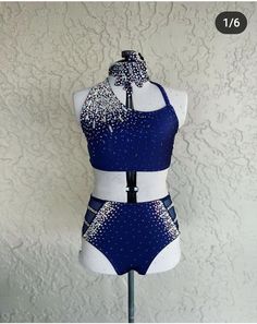 a mannequin wearing a blue and white swimsuit with silver sequins