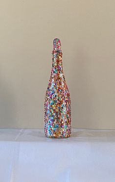 a bottle that is covered in colorful beads