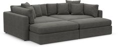 a large gray couch with pillows on it