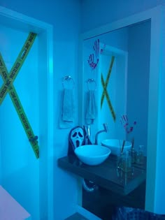 the bathroom is lit up with blue light and measuring tape on the wall next to the sink