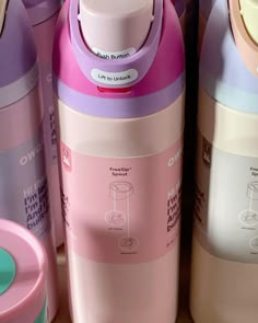 thermos bottles are lined up next to each other in different colors and designs