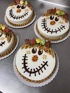 four decorated cakes sitting on top of a table