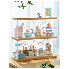 three tiered display case filled with lots of toys and figurines on wooden shelves