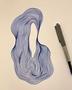 a drawing of a woman's head with wavy hair on paper next to a pen