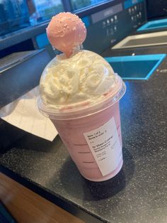 a pink drink with whipped cream on top