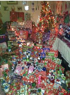 a room filled with lots of presents under a christmas tree