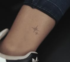 a woman's foot with a small star tattoo on her left side ribcage