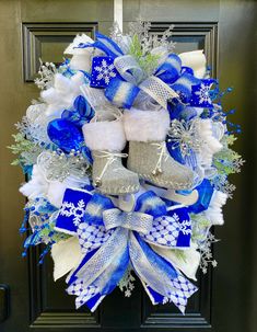 a blue and white christmas wreath with baby booties