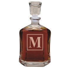 an empty glass bottle with a monogram on it