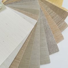 the colors of carpet samples are laid out on top of each other, including beiges and browns