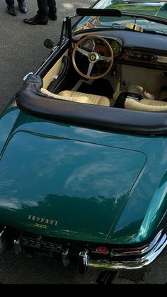 a green sports car parked on the street