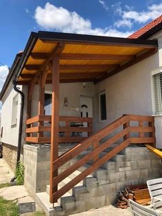 an outdoor covered patio with stairs leading up to it