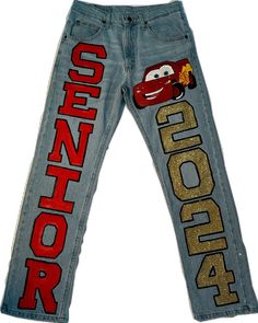 a pair of jeans with cars on the side and gold sequins in the back