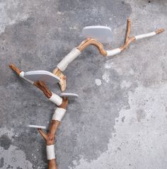 two white and brown chairs sitting on top of a cement floor next to each other