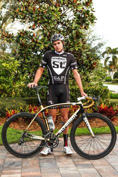 a man is standing next to his bike