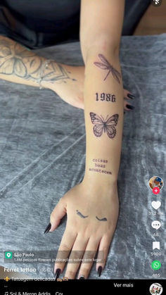 a woman's arm with tattoos on it and the date tattooed to her wrist