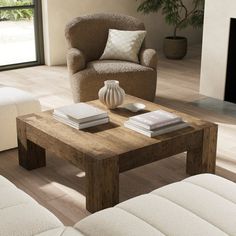 a living room with two couches and a coffee table in front of a fireplace