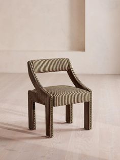 a striped chair sitting on top of a hard wood floor