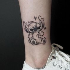 a small tattoo on the ankle of a person with a koala bear in it