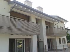 an apartment building with two balconies on the second floor and balcony railings