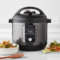 an open crock pot next to a bowl of food