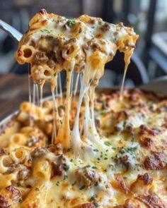 a close up of a pizza being lifted with a fork