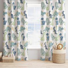 a child's room with dinosaur curtains and toys in front of the window,