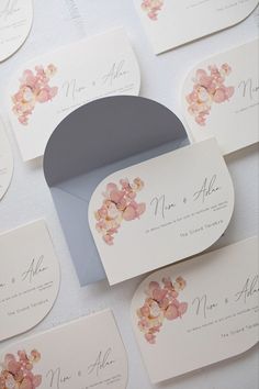 the wedding stationery is laid out on top of each other