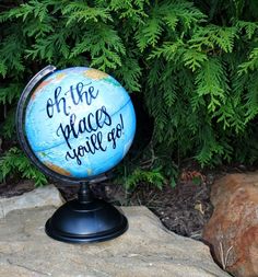 a blue globe with the words oh the places you'll go written on it