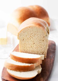 sliced loaf of bread sitting on top of a wooden cutting board