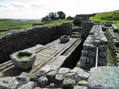 an old stone structure with two bowls on it